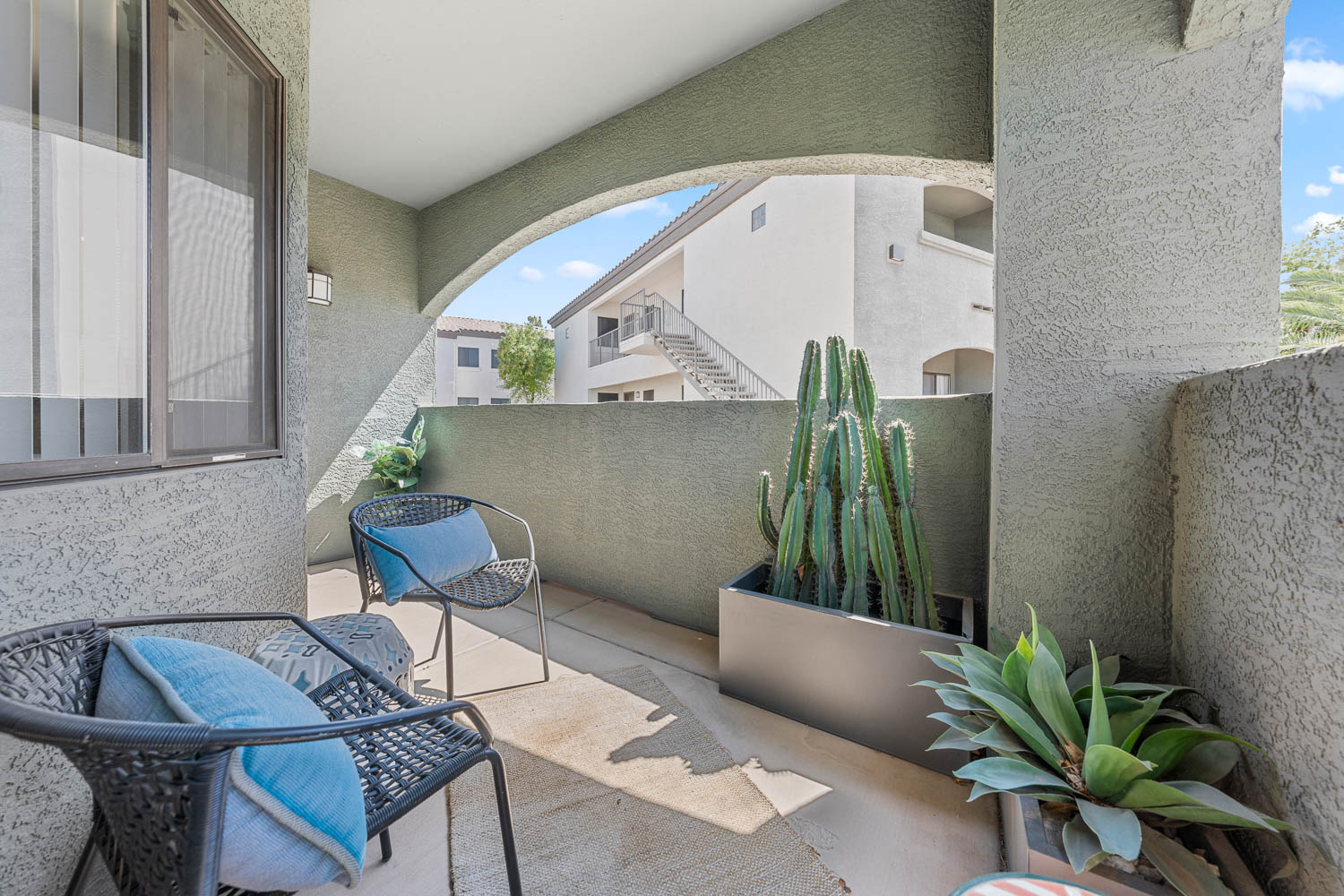 Private balcony with view of trees and other buildings