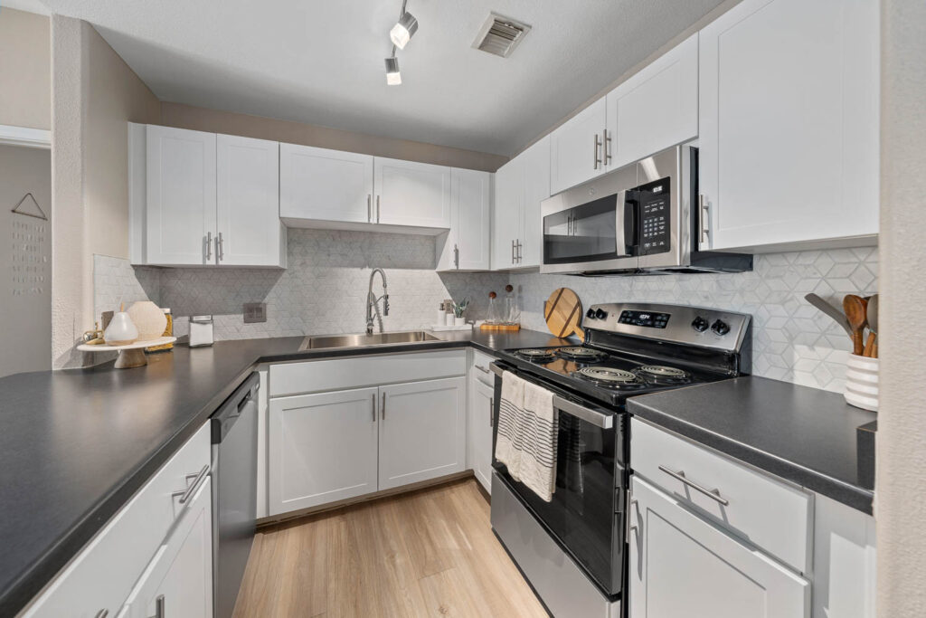 Kitchen with stainless steel appliances and tile backsplash