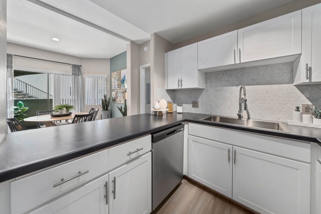 Kitchen with stainless steel appliances and tile backsplash