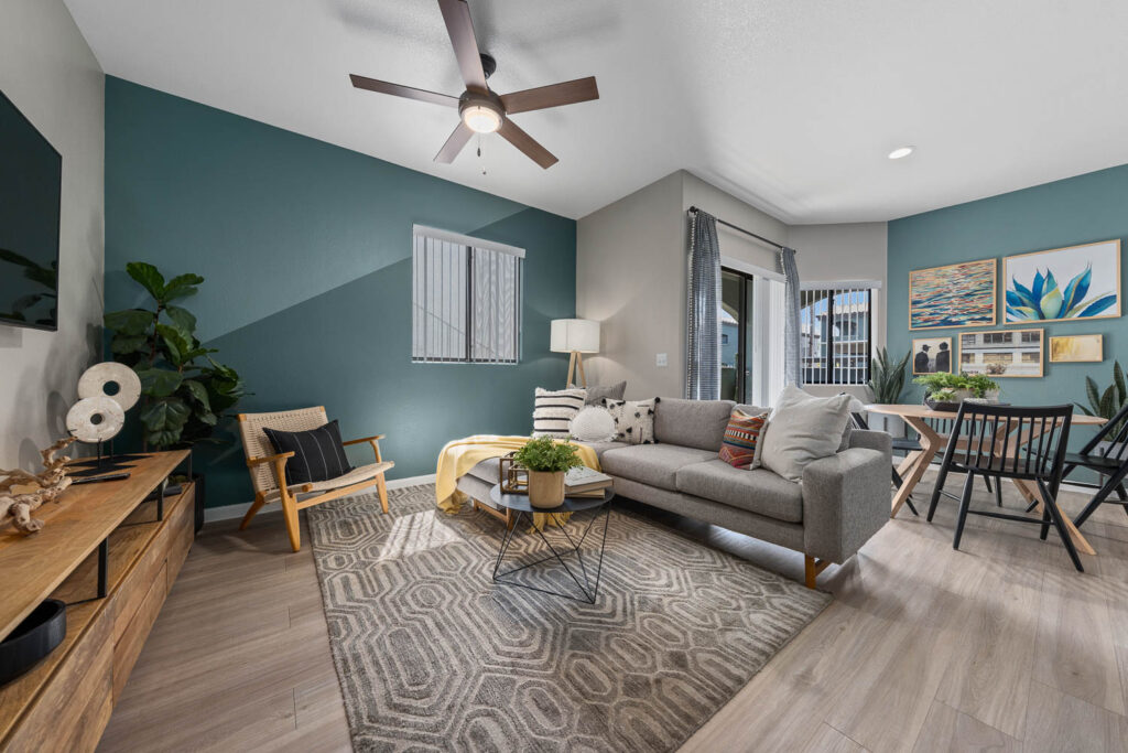 Living and dining space with blue accent walls at Palm Court apartments near Downtown Phoenix