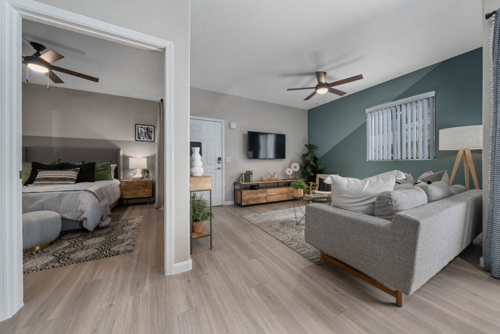 Living room with blue accent wall and bedroom