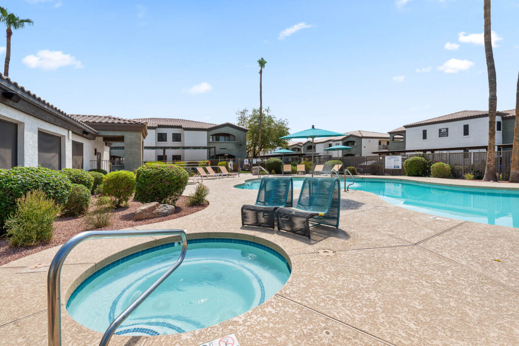 Outdoor pool and hot tub with patio space